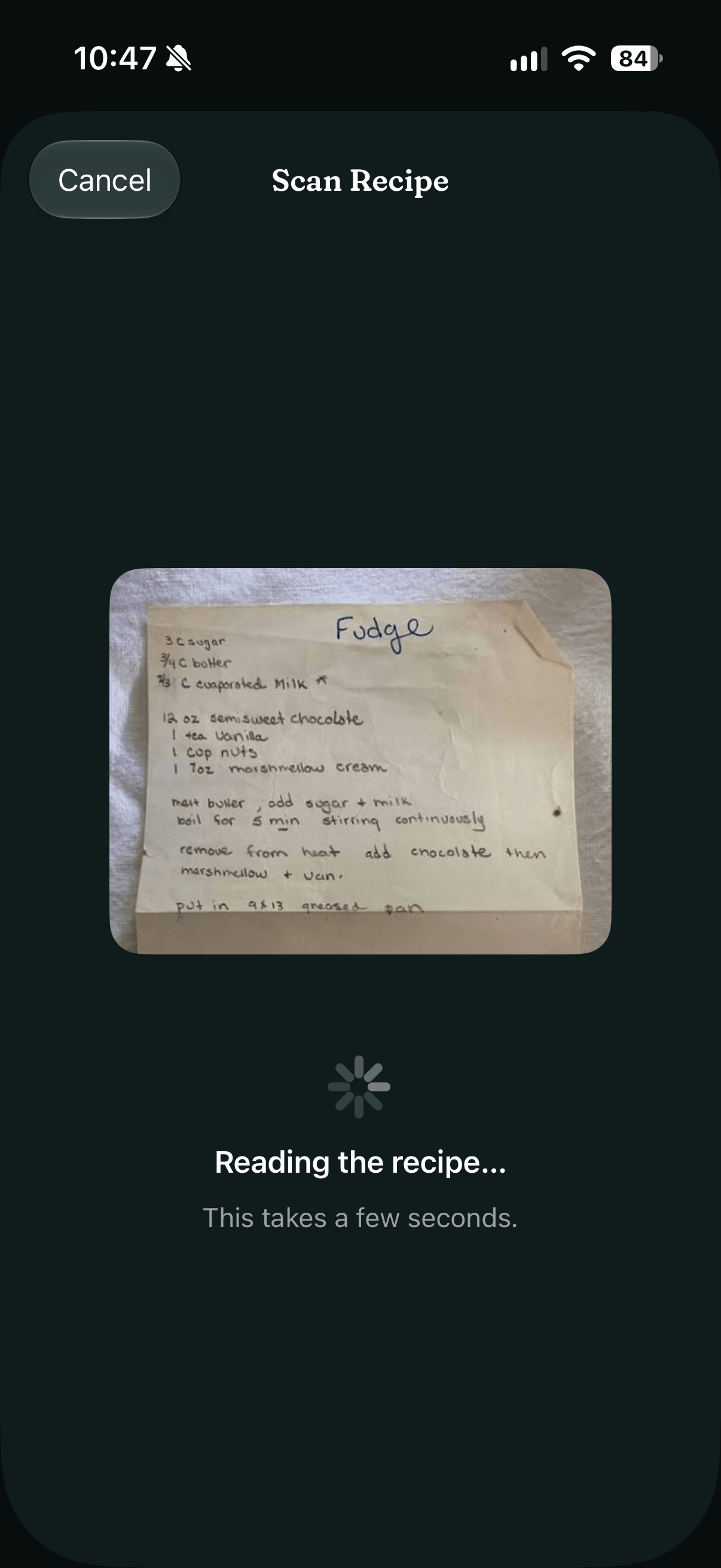 The Scan Recipe sheet: a photo of a handwritten fudge recipe card above a spinner and 'Reading the recipe…', in dark mode